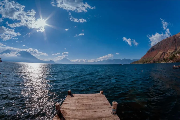 Wooden dock on Lake Atitlán with volcanoes on the horizon